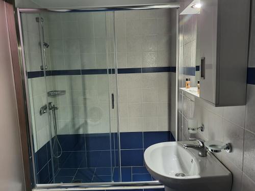 a bathroom with a shower and a sink at Stoupa Lefktro 9 in Kalamata