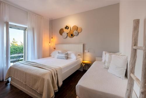 a bedroom with two beds and a window at Villa Giorgianna -near Aliki beach with pool in Aliki