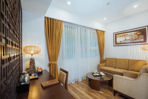 a living room with a couch and a table at Thang Long Opera Hotel in Hanoi