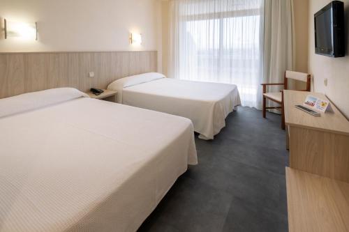 Cama o camas de una habitación en Hotel Marinada