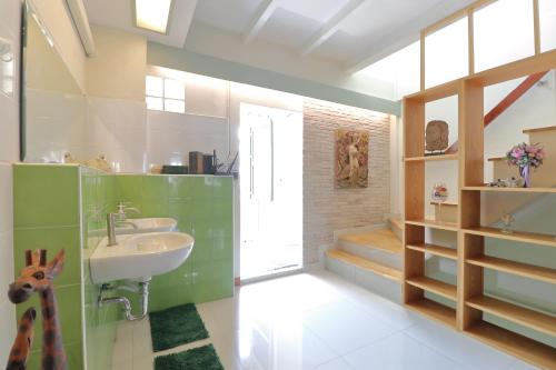 a bathroom with a sink and a window at Saen Sabai Hostel in Lat Krabang