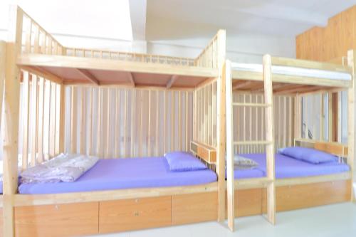 a bunk bed with two bunk beds in a room at Saen Sabai Hostel in Lat Krabang