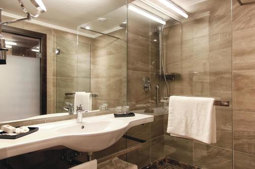 a bathroom with a sink and a shower at Hotel Riu Tikida Dunas - All inclusive in Agadir