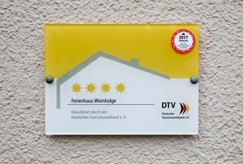 a yellow and white sign on a wall at Weinlodge am Geissberg in Eberstadt
