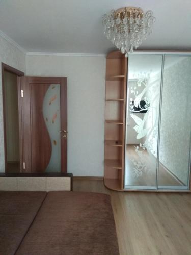 a room with a glass cabinet and a chandelier at 2-х комнатная квартира in Odesa