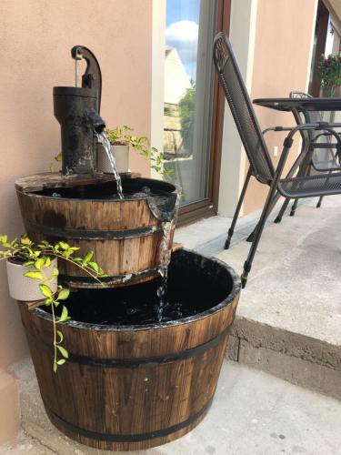 a water fountain in a wooden barrel with at U Trautyho in Zadní Chodov