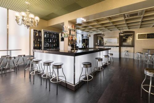 a bar in a room with stools around it at Crisol Conde Rodrigo in Ciudad-Rodrigo