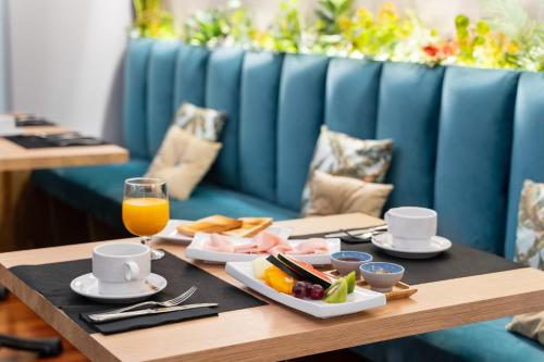 a table with a tray of food and a glass of orange juice at Crisol Conde Rodrigo in Ciudad-Rodrigo