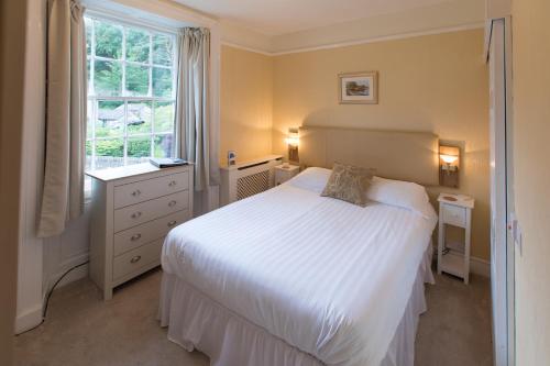 a bedroom with a white bed and a window at Rydal Lodge in Rydal