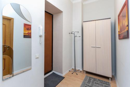 a hallway with a door and a mirror at Studiominsk 6 Apartments in Minsk