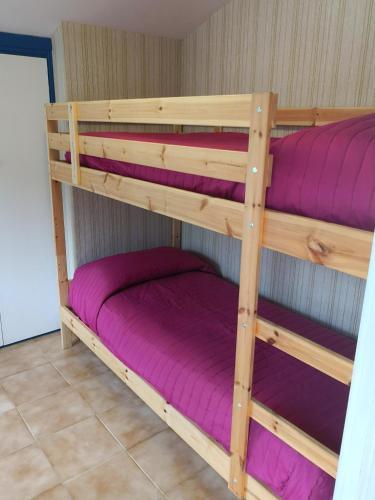 two bunk beds in a room with purple sheets at Casa di Venere - Fossacesia in Fossacesia