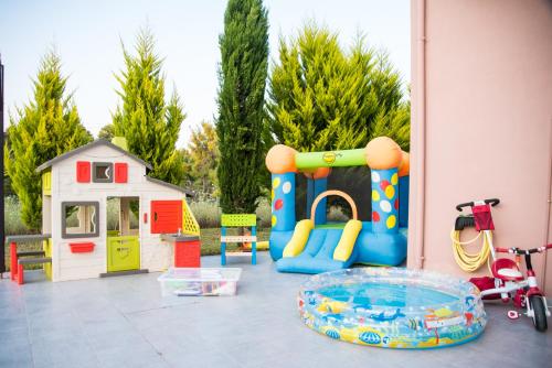 a play area with a playground and a play house at Sani villa perfect for family vacations in Sani Beach