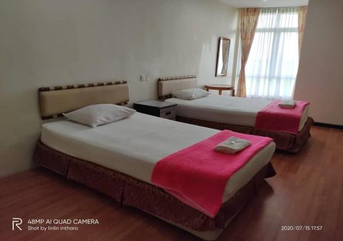 Ein Bett oder Betten in einem Zimmer der Unterkunft Soo Guan Villa