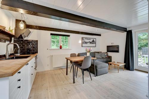 a kitchen and living room with a table and a couch at Hørhavegården B&B in Højbjerg