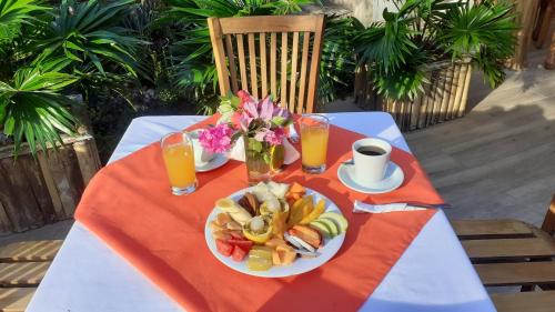 a table with a plate of food and drinks on it at San Simian Lodge in La Laguna