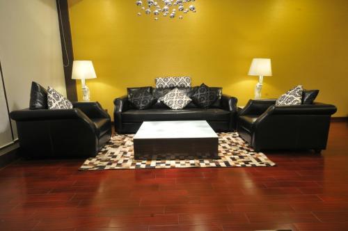 a living room with two couches and a coffee table at The Fern Residency Rajkot in Rajkot