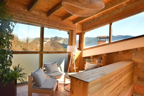 a room with windows and a table and chairs at El Jou Nature in Sant Corneli de Cercs 