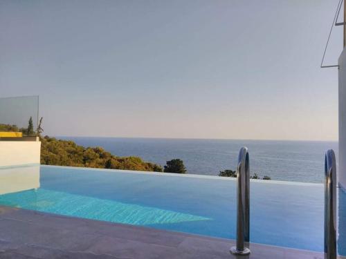 a swimming pool with a view of the ocean at Zante Fiore Suites in Xirokástellon
