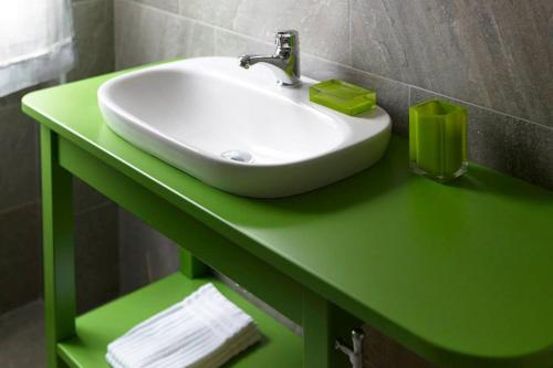 a green bathroom counter with a sink on it at La Vecchia Latteria - B & B in Gardone Riviera