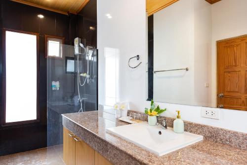 a bathroom with a sink and a shower at Lady Naya Villas - SHA Extra Plus in Rawai Beach