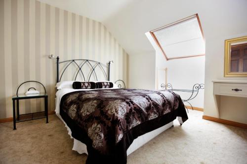 a bedroom with a large bed and a window at Ardawn House in Galway