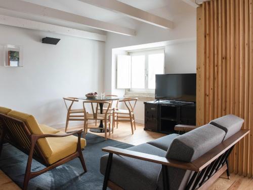 a living room with a couch and a table at Madalena Orquidea Living Apartments in Lisbon