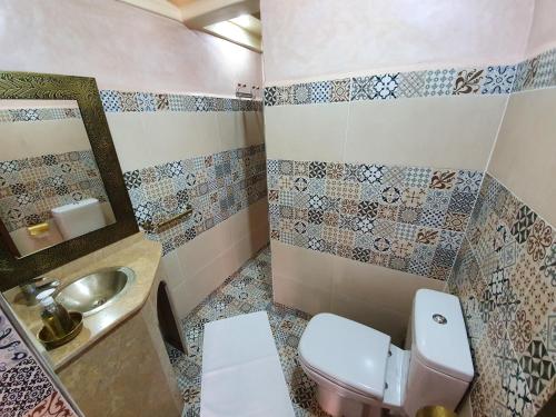 a bathroom with a toilet and a sink at Dar Assarou - Toubkal National Park Lodge in Imlil