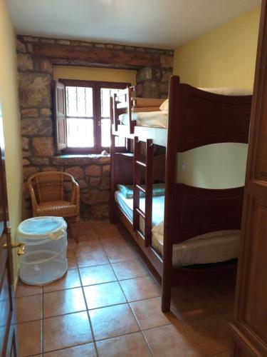 Pokój z 4 łóżkami piętrowymi i oknem w obiekcie CASA FELISA w mieście Pola de Somiedo