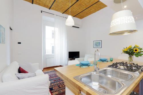 a kitchen and living room with a sink at RomeAsYouLike - Colosseo Experience 23 in Rome