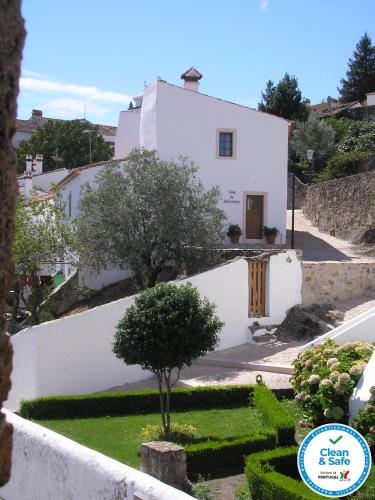 a white house with a tree in front of it at Casa da Silveirinha in Marvão