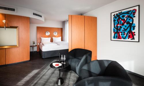 a hotel room with a bed and a tv at Penck Hotel Dresden in Dresden