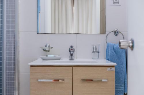 a bathroom with a sink and a mirror at Hotel Opera in Larnaca