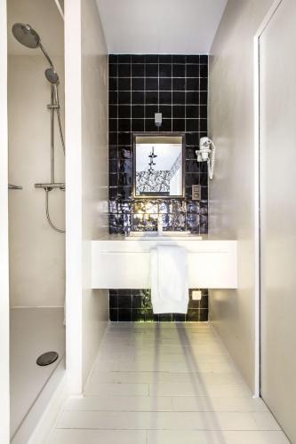 a bathroom with a sink and a shower at La Maison Haute guesthouse in Brussels