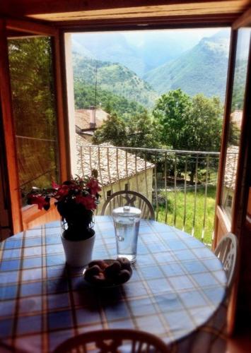 a table with a view of the mountains from a window at Majellame in Caramanico Terme