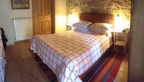 a bedroom with a large bed with two pillows at Majellame in Caramanico Terme
