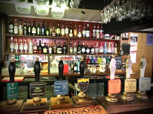 a bar with a lot of bottles of alcohol at The White Horse Inn, Clun in Clun