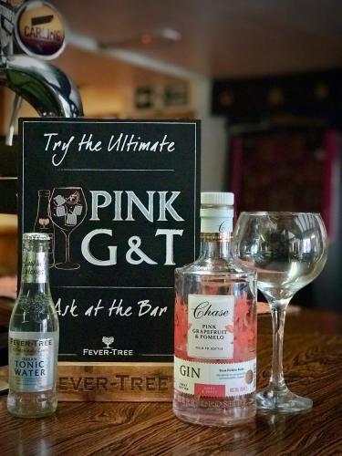 a bottle of pink cat next to a glass of wine at The White Horse Inn, Clun in Clun