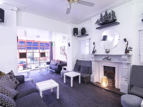 a living room with a couch and a fireplace at The Marsden Hotel in Blackpool