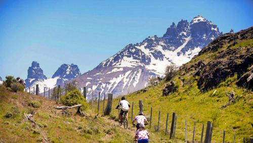 a group of people riding bikes on a mountain trail at Casa Cerro Castillo in Villa Cerro Castillo
