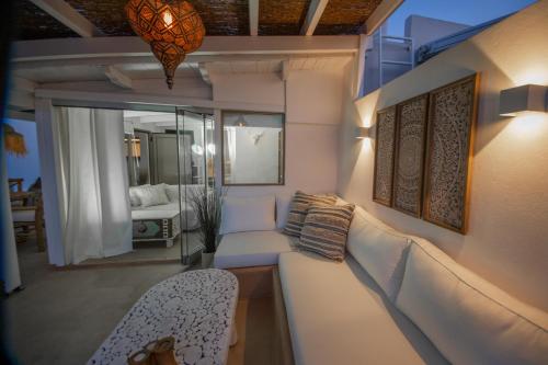 a living room with a couch and a chair at The Roof-Top in Megalochori