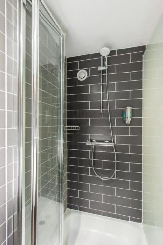 a bathroom with a shower with a glass door at Holiday Inn Express Strathclyde Park M74, Jct 5 by IHG in Motherwell