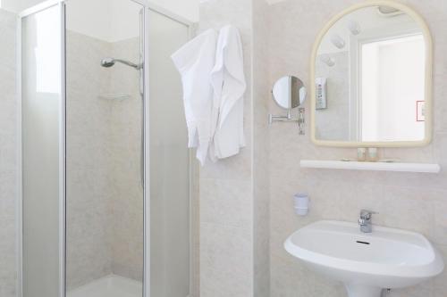 a bathroom with a shower and a sink and a mirror at HOTEL ZI'NTONIO in Scala