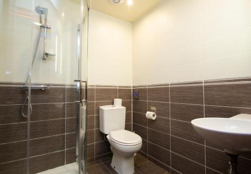 a bathroom with a toilet and a sink at The Auld Kirk in Ballater