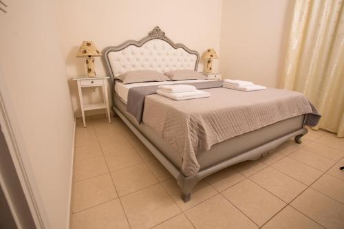 a bedroom with a bed with two towels on it at Pistakion Houses in Egina