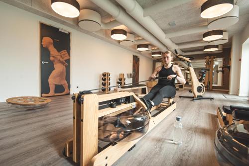 a woman exercising on a treadmill in a gym at Hotel Brandan in Tórshavn