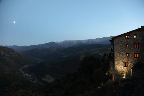 a building on the side of a mountain at dusk at Paller Cal Cintet in Aristot
