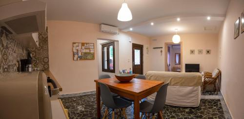 a kitchen and dining room with a table and a dining room at The house under the rocks of Meteora 1 in Kalabaka