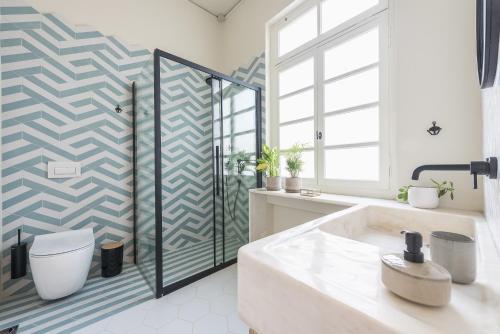 a bathroom with a toilet and a shower at Moon And Stars Athens in Athens