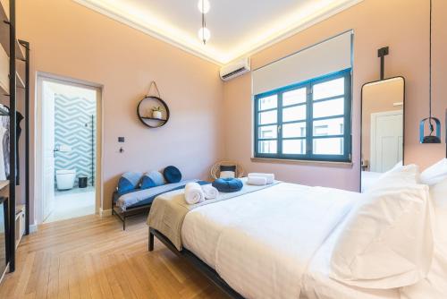 a bedroom with a large white bed and a couch at Moon And Stars Athens in Athens