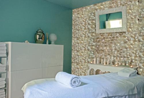 a bedroom with a bed and a mirror on a wall at Hôtel Villa Marie Saint Tropez in Saint-Tropez